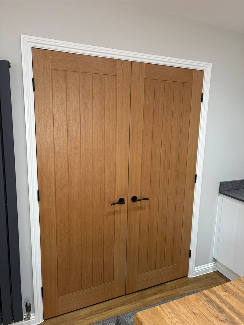 Oak double doors with matt black hardware, fitted by Stenhouse