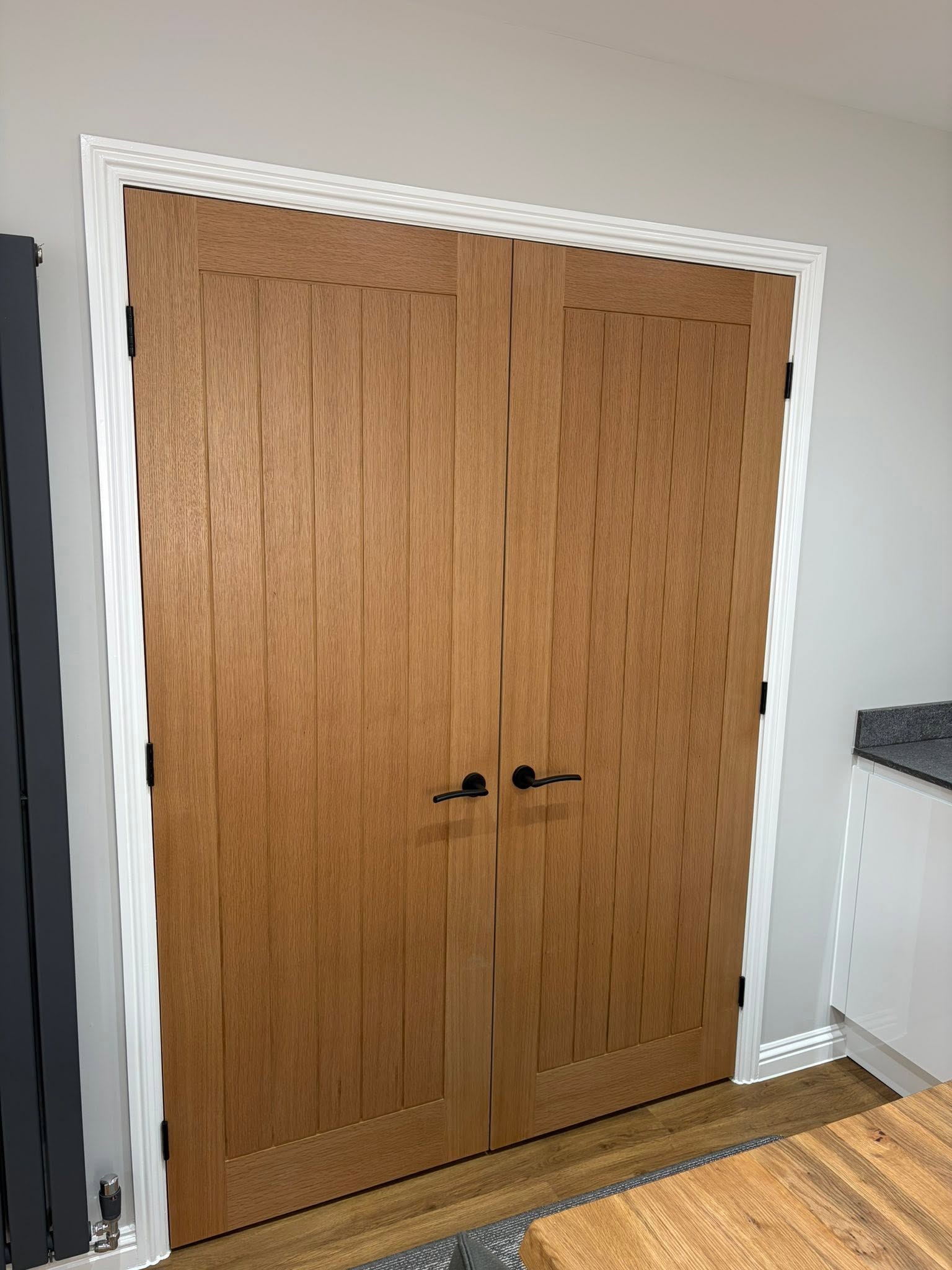 Oak double doors with matt black hardware, fitted by Stenhouse